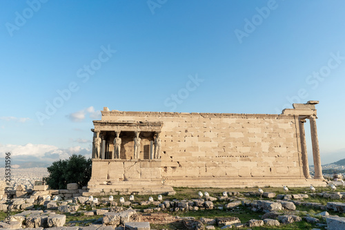 The ancient Erechtheion temple with the beautiful Caryatid pillars on the porch, on the Acropolis in Athens, Greece.