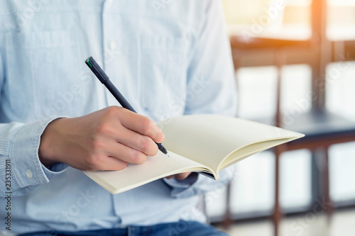 Businessman holding pen and notebook, Writing something idea on note or check list.