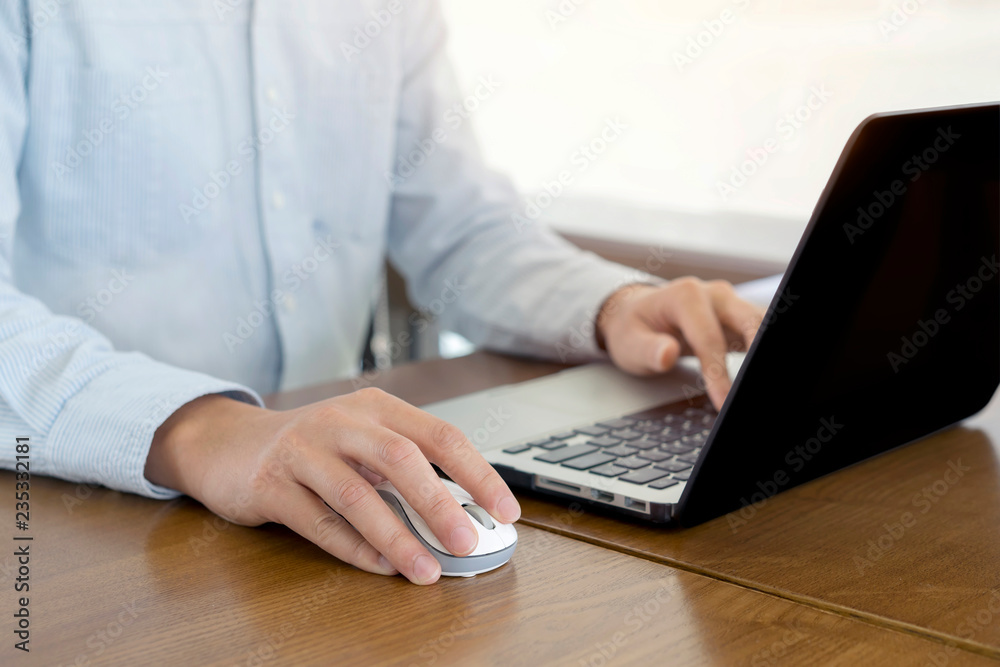 Close up, Businessman hands using mouse and computer laptop, browsing internet information and searching web, working outside. Close up, Businessman hands using mouse and computer laptop, browsing internet information and searching web, working outside.