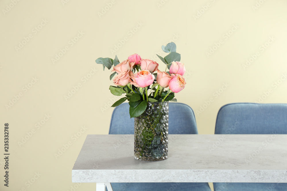 Vase with beautiful flowers as element of interior design on table in room. Space for text Vase with beautiful flowers as element of interior design on table in room. Space for text