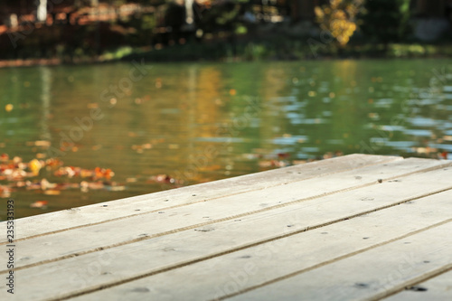 Fototapeta Naklejka Na Ścianę i Meble -  Wooden pier near pond. Space for text
