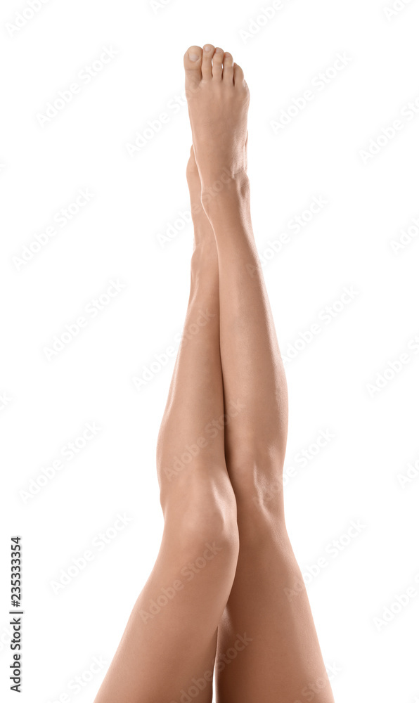 Young woman with beautiful long legs on white background, closeup