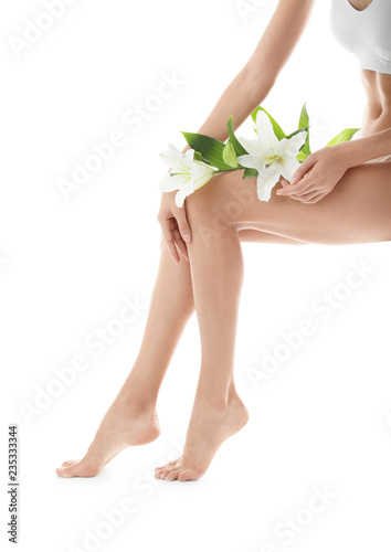 Fototapeta Naklejka Na Ścianę i Meble -  Young woman with beautiful long legs on white background, closeup