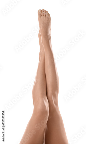 Young woman with beautiful long legs on white background  closeup