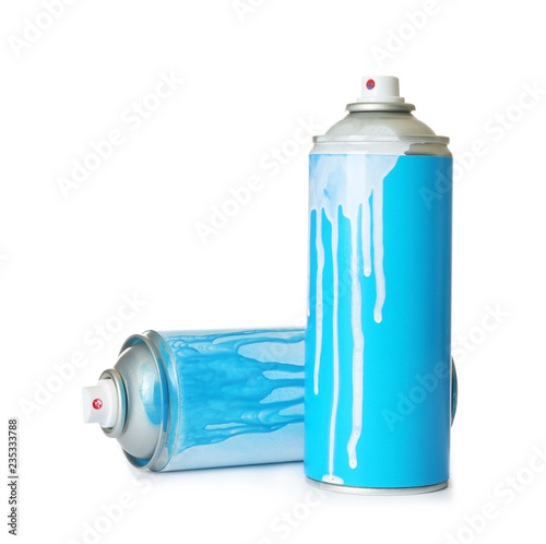 Used cans of spray paint on white background