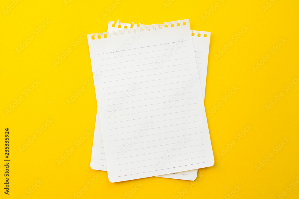 empty paper of notebook on yellow background with school concept. empty paper of notebook on yellow background with school concept.