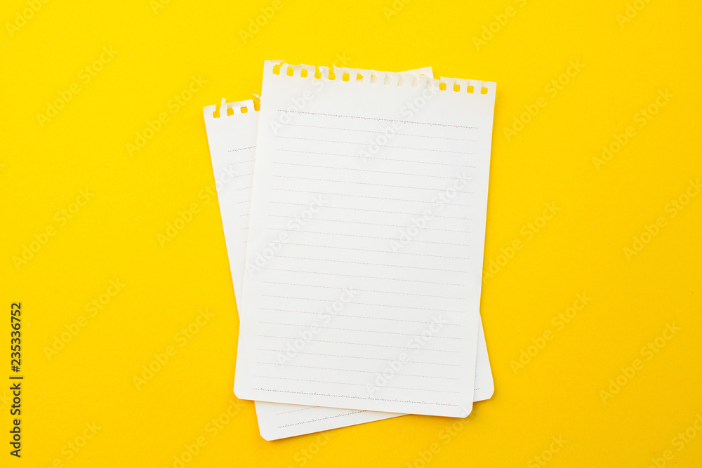 empty paper of notebook on yellow background with school concept. empty paper of notebook on yellow background with school concept.