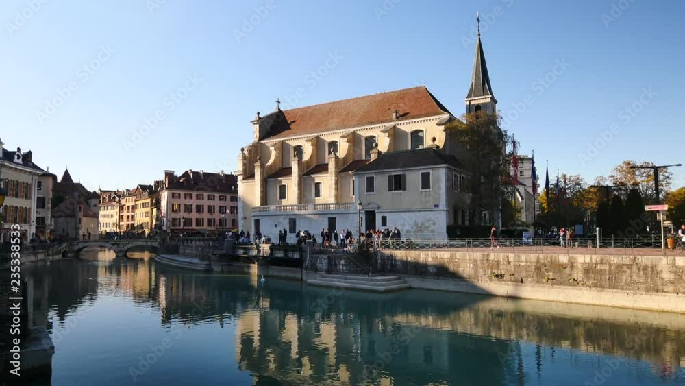 Canal of the old town of Annecy. View on the quays and a church in the background. Sunny day, blue sky. Canal of the old town of Annecy. View on the quays and a church in the background. Sunny day, blue sky.