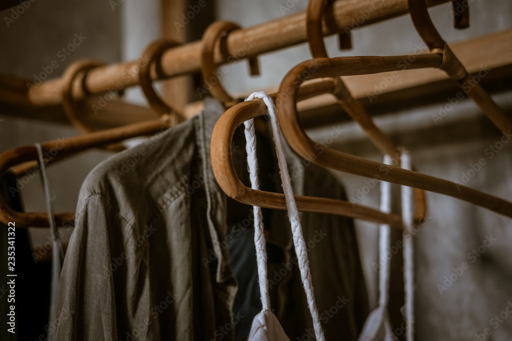 Boho chic open wardrobe, clothing rack, rattan wooden hangers, Fashion blogging concept, neutral colors. Loft bedroom interior design. Boho chic open wardrobe, clothing rack, rattan wooden hangers, Fashion blogging concept, neutral colors. Loft bedroom interior design.