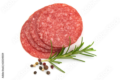 Salami for Pizza. Slices of smoked salami with rosemary and peppercorns, isolated on a white background. Top view