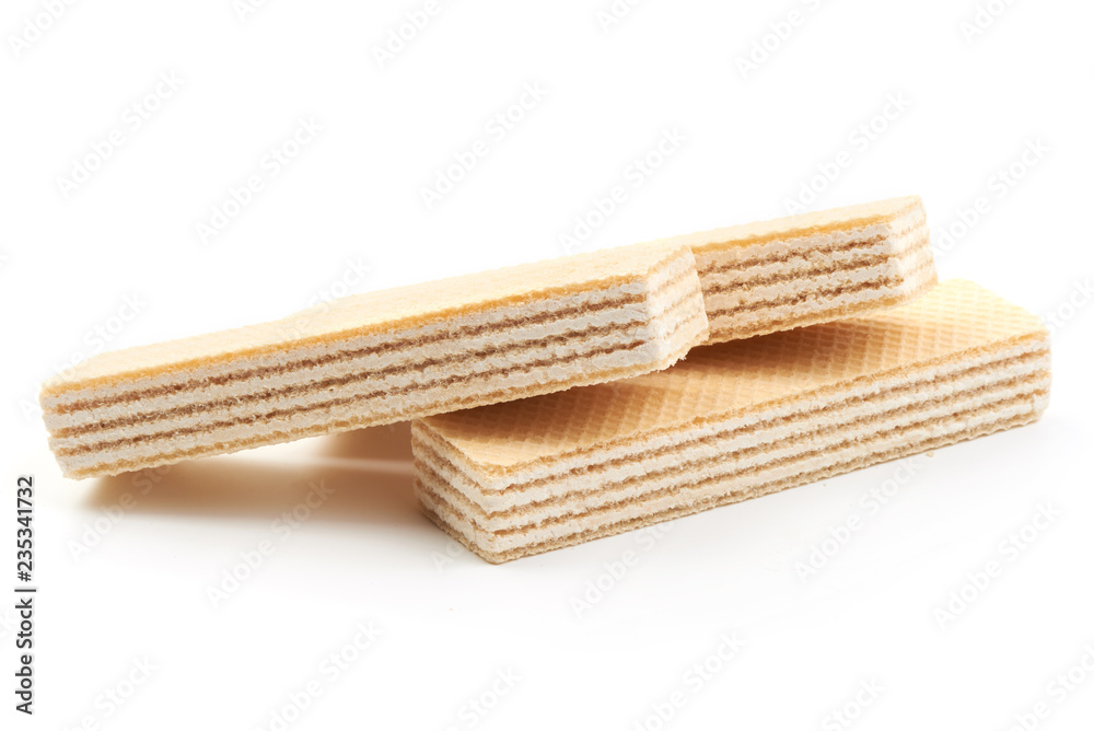 Crunchy vanilla waffles, isolated on a white background. Close-up. Crunchy vanilla waffles, isolated on a white background. Close-up.