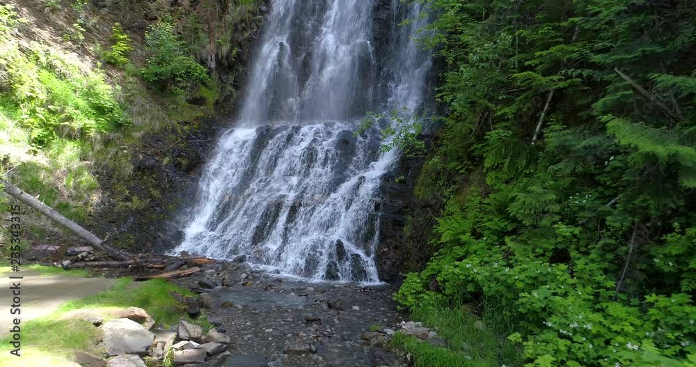 Majestic waterfall in Nakusp, Vancouver, Canada. Drone flying. Aerial view with mountain background. Majestic waterfall in Nakusp, Vancouver, Canada. Drone flying. Aerial view with mountain background.