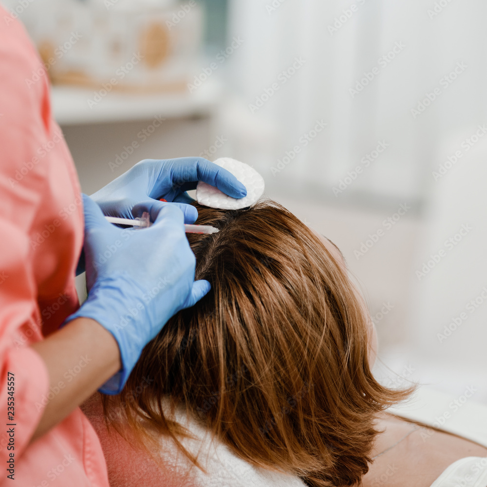 Naklejka premium Cosmetologist doing injection