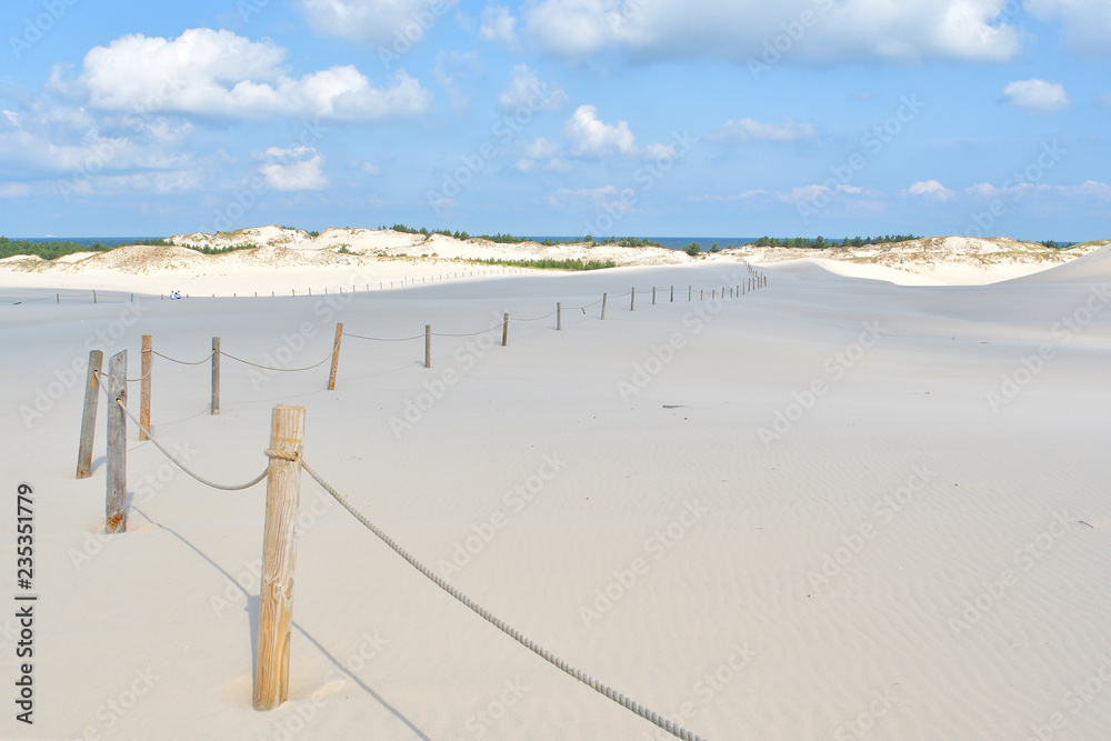 Wooden fence with rope, Slowinski national park, sand dune Leba, Poland