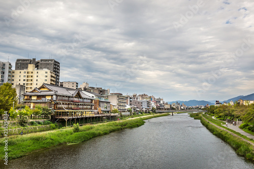 A river crossing the city of Kyoto in a cloudy day in Japan © LMspencer