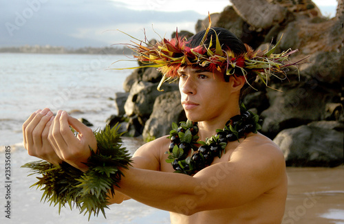 Εκτύπωση καμβά Male Hula Dancer poses on the beach in a hula dance.