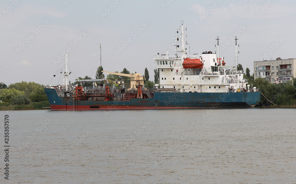 Dredger for absorption of trailer bunker during work on land reclamation for new ports. Suction dredge. Dredging in fairway of Dinai River. Cutter suction dredgers when working on land reclamation Dredger for absorption of trailer bunker during work on land reclamation for new ports. Suction dredge. Dredging in fairway of Dinai River. Cutter suction dredgers when working on land reclamation