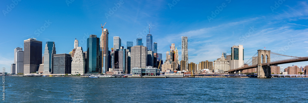 Panoramic view of New York City Manhattan skyline and Brooklyn bridge.