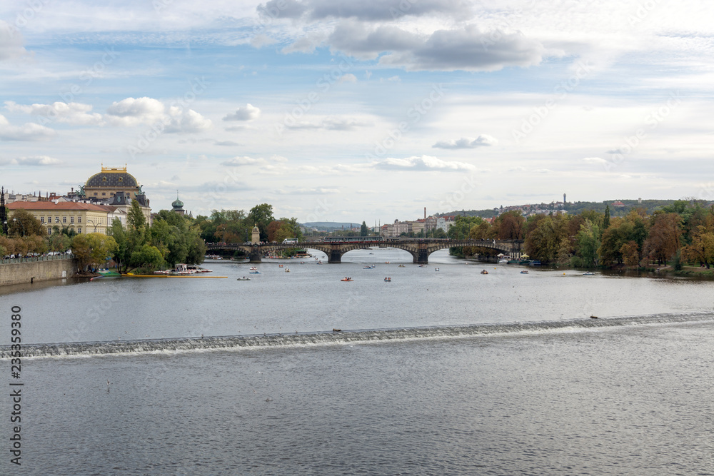 Prague waterfront panorama on a cloudy day, with Vltava river, Legion bridge and the National Theater landmarks in sight 