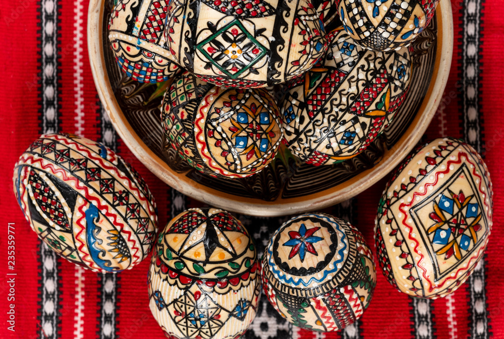 Set of wooden Easter eggs painted in traditional Eastern European style with a floral or geometric design.