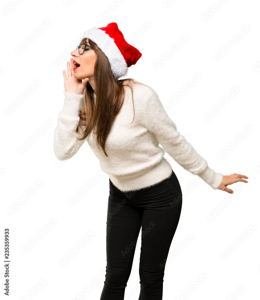 Girl with celebrating the christmas holidays shouting to the lateral and announcing something on isolated white background Girl with celebrating the christmas holidays shouting to the lateral and announcing something on isolated white background