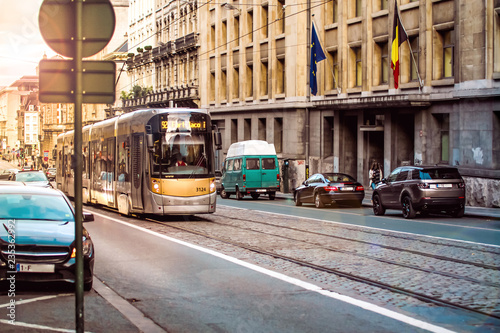 Brussels, Kingdom of Belgium.  Tram and few cars on the street. Sunset. Belgian road.