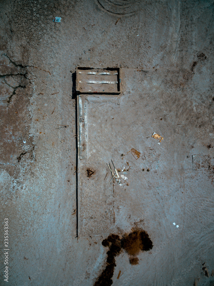 Aerial drone view looking down at the remains of a house along the shore of the Salton Sea in Southern California Aerial drone view looking down at the remains of a house along the shore of the Salton Sea in Southern California