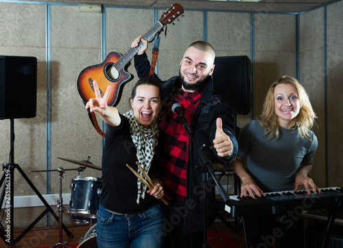 expressive group of rock musicians posing with instruments