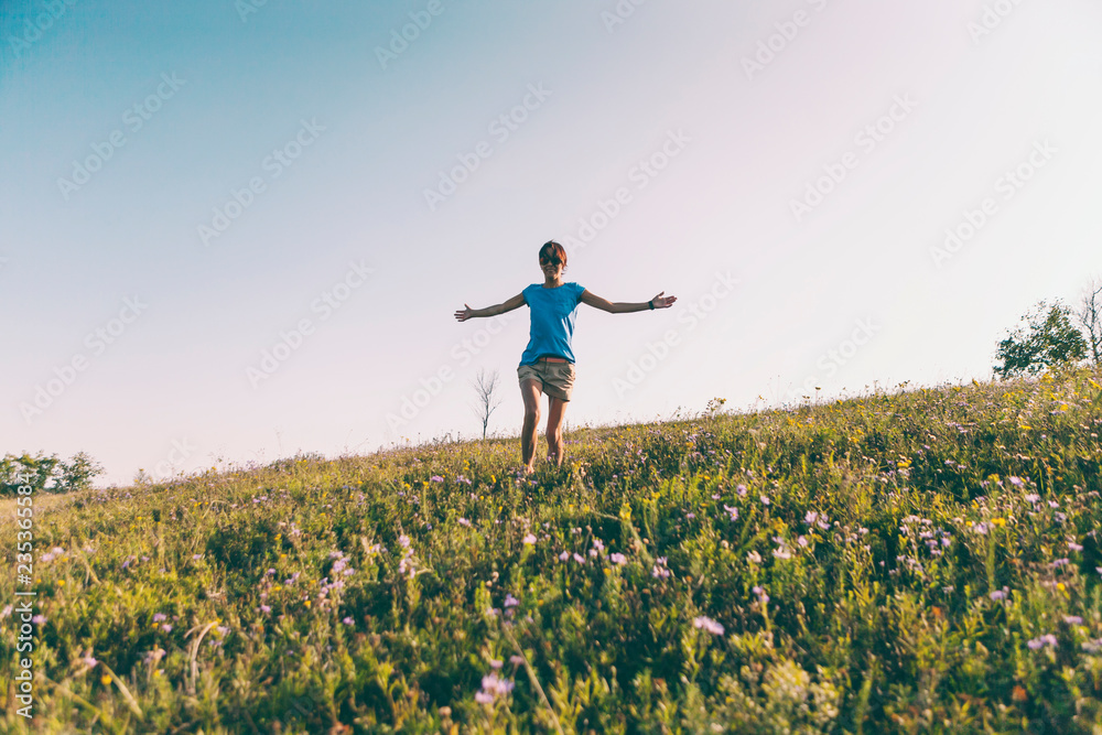 A girl is walking along the field. A girl is walking along the field.