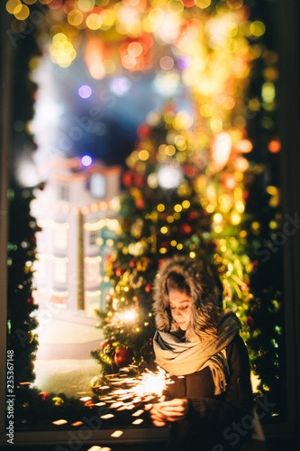 Female holding burning sparkler