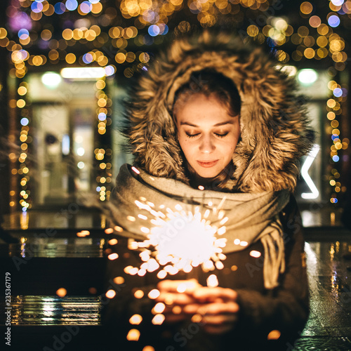 Female holding burning sparkler