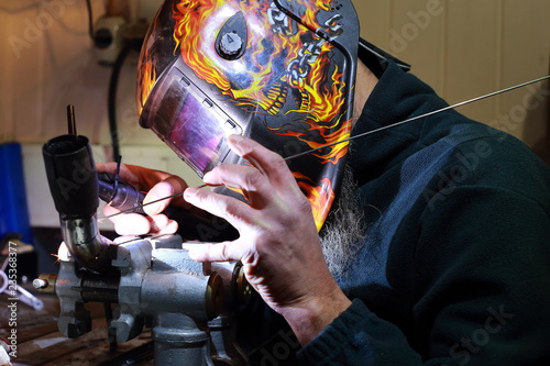welder welds motorcycle parts