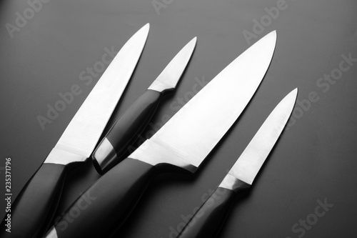 Collection of kitchen knives on black bfckground photo