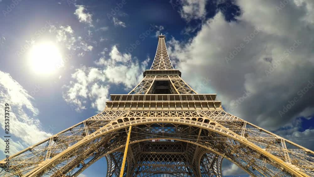 Clouds passing over world famous Eiffel tower in time lapse effect. Paris, France
