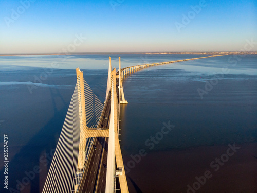 Vasco da Gama Bridge landscape at sunrise. One of the longest bridges in the world. Lisbon is an amazing tourist destination because its light, its monuments. Portugal landmark.