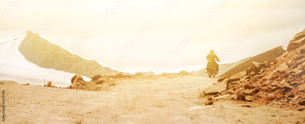 Naklejka premium Motorbike traveler rides on mountain pass in indian Himalaya