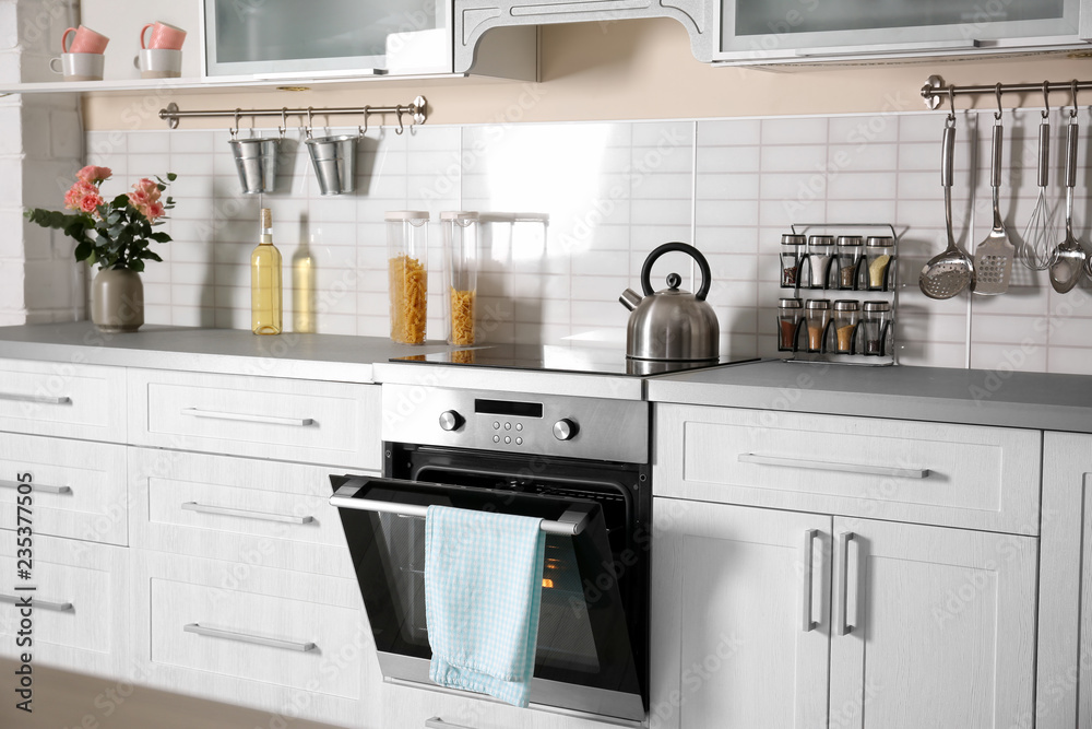 Light modern kitchen interior with new oven Stock Photo | Adobe Stock