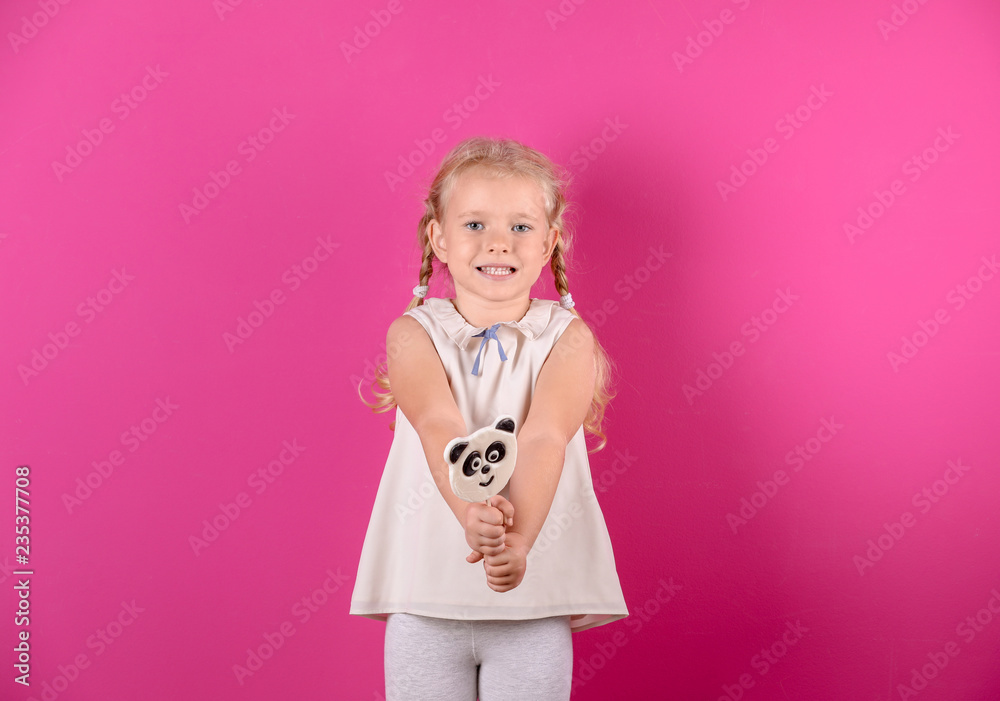 Cute little girl with candy on color background Cute little girl with candy on color background