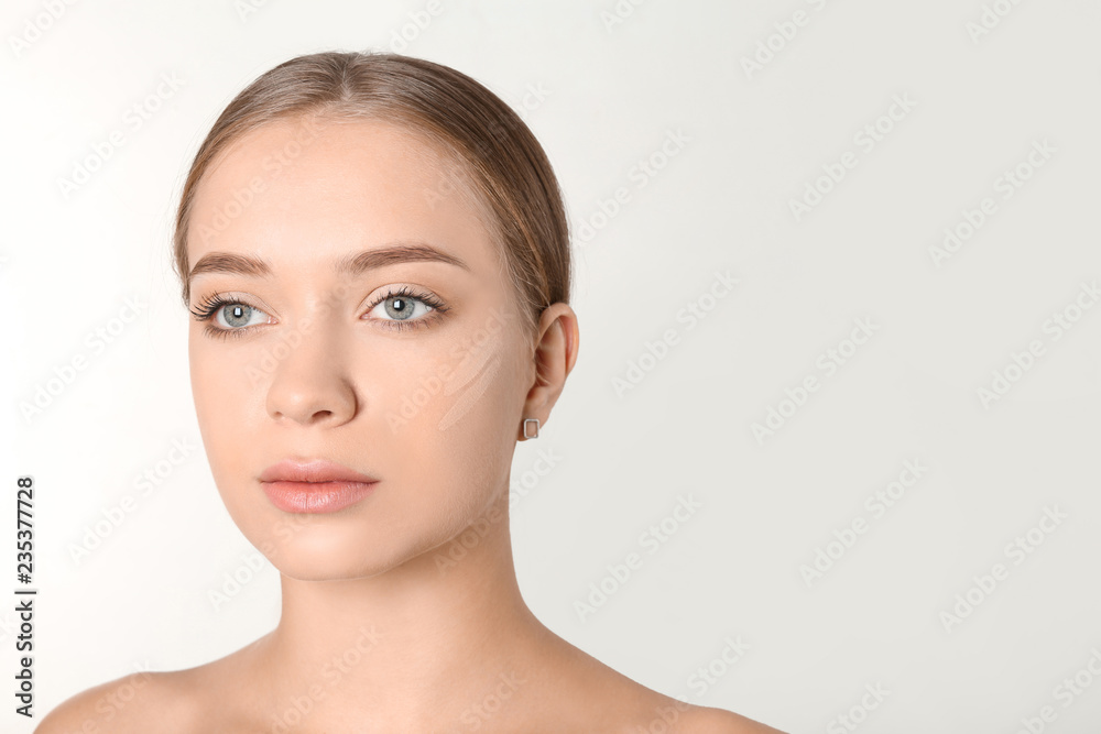 Naklejka premium Portrait of beautiful young woman with makeup smears on face against white background