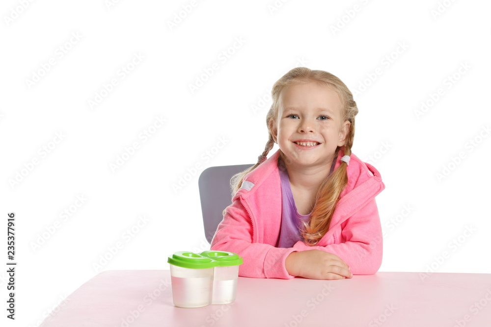 Cute little child with water cups at table on white background. Painting accessory Cute little child with water cups at table on white background. Painting accessory
