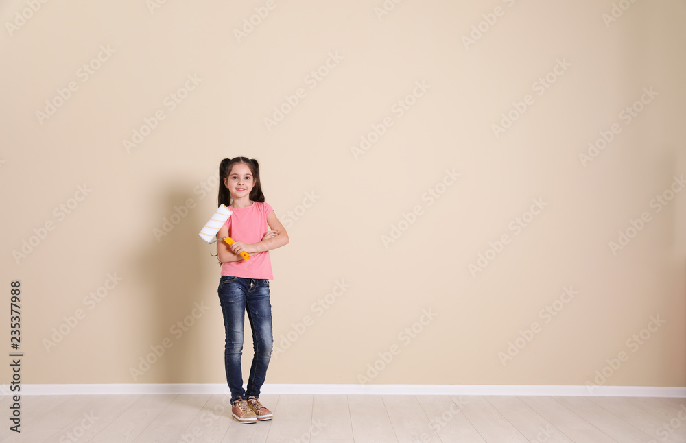 Child with roller brush near color wall. Space for text Child with roller brush near color wall. Space for text