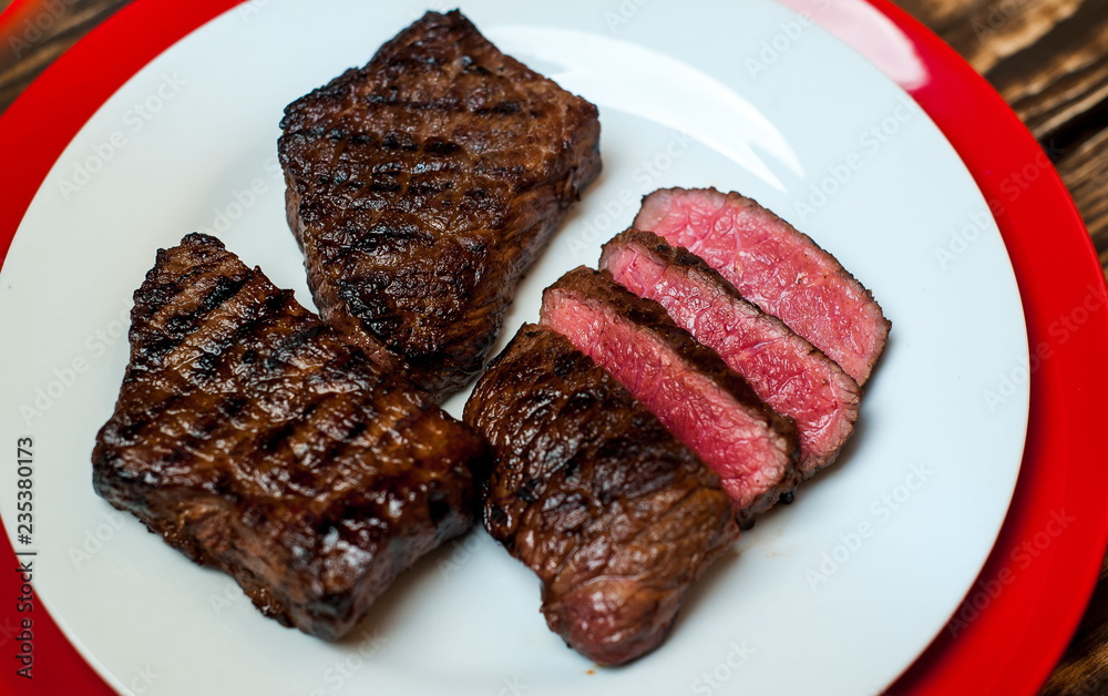 steak, roast beef on a plate on a wooden background steak, roast beef on a plate on a wooden background
