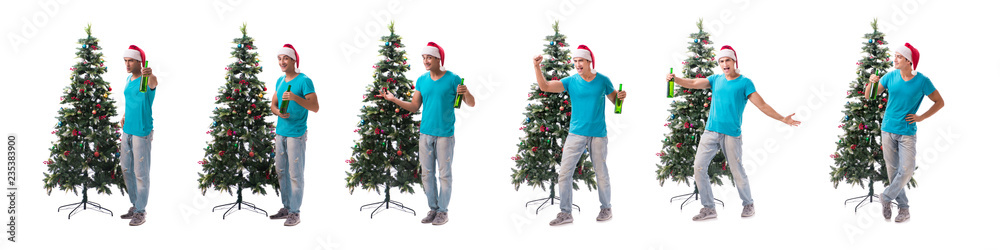 Young man decorating christmas tree isolated on white Young man decorating christmas tree isolated on white
