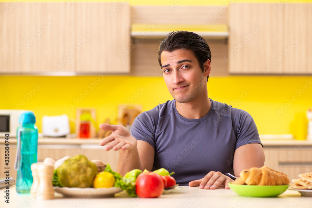 Man having hard choice between healthy and unhealthy food Man having hard choice between healthy and unhealthy food