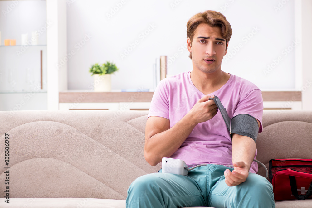 Sick man at home with first aid kit Sick man at home with first aid kit