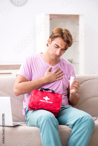 Sick man at home with first aid kit