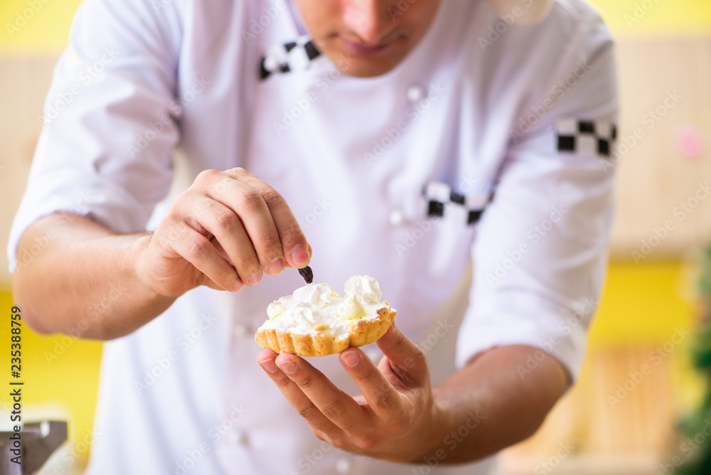 Young chef husband working in kitchen at Christmas eve Young chef husband working in kitchen at Christmas eve