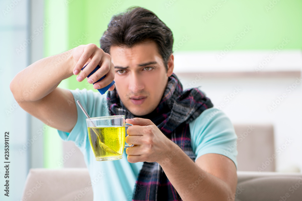 Young handsome man suffering from illness at home Young handsome man suffering from illness at home