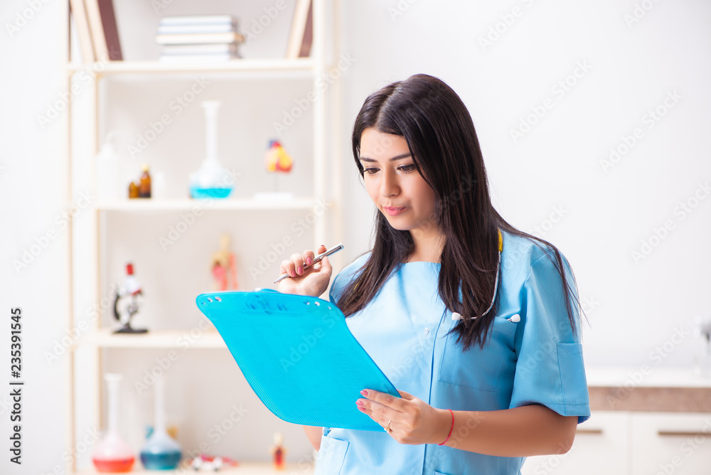 Young beautiful female doctor working in the clinic Young beautiful female doctor working in the clinic