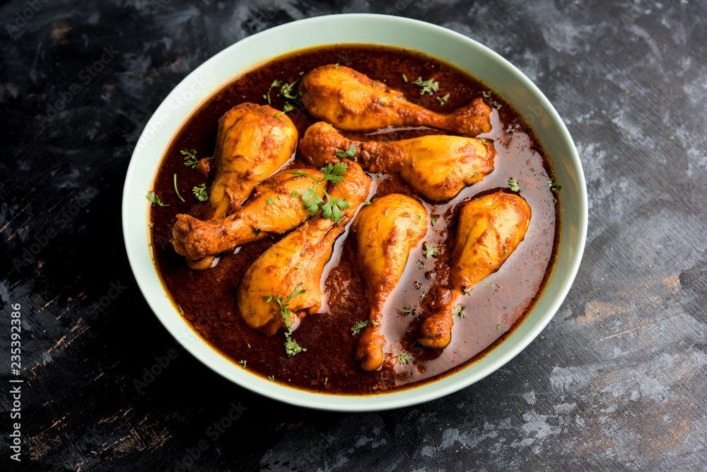 Chicken leg / drumstick curry or Murg Tangri/tangdi masala. Served in a bowl over moody background. Selective focus Chicken leg / drumstick curry or Murg Tangri/tangdi masala. Served in a bowl over moody background. Selective focus